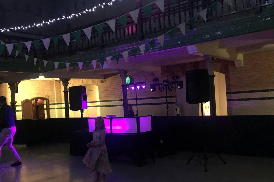 Wedding DJ setup with lighting at a venue